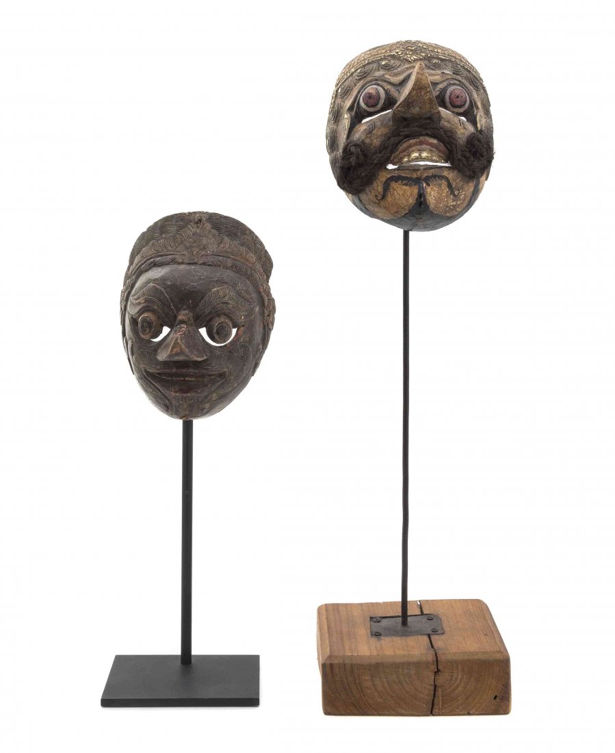 Two Balinese Masks, Height of taller 7 inches.: Two Balinese Masks, each having polychrome decoration and raised on display stands. Height of taller 7 inches.