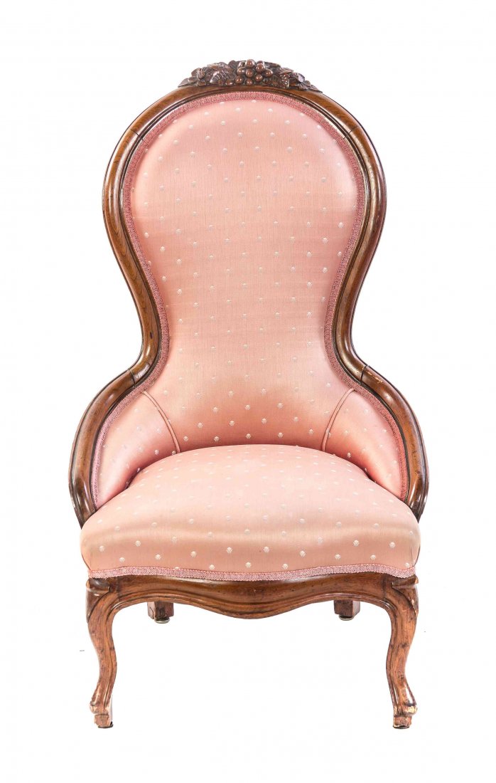 A Victorian Walnut Slipper Chair, Height 41 inches.: A Victorian Walnut Slipper Chair, having a foliate and grape carved crest over the upholstered back and seat, raised on shaped legs. Height 41 inches. Property from the Estate of Norman and Dorothy Ho