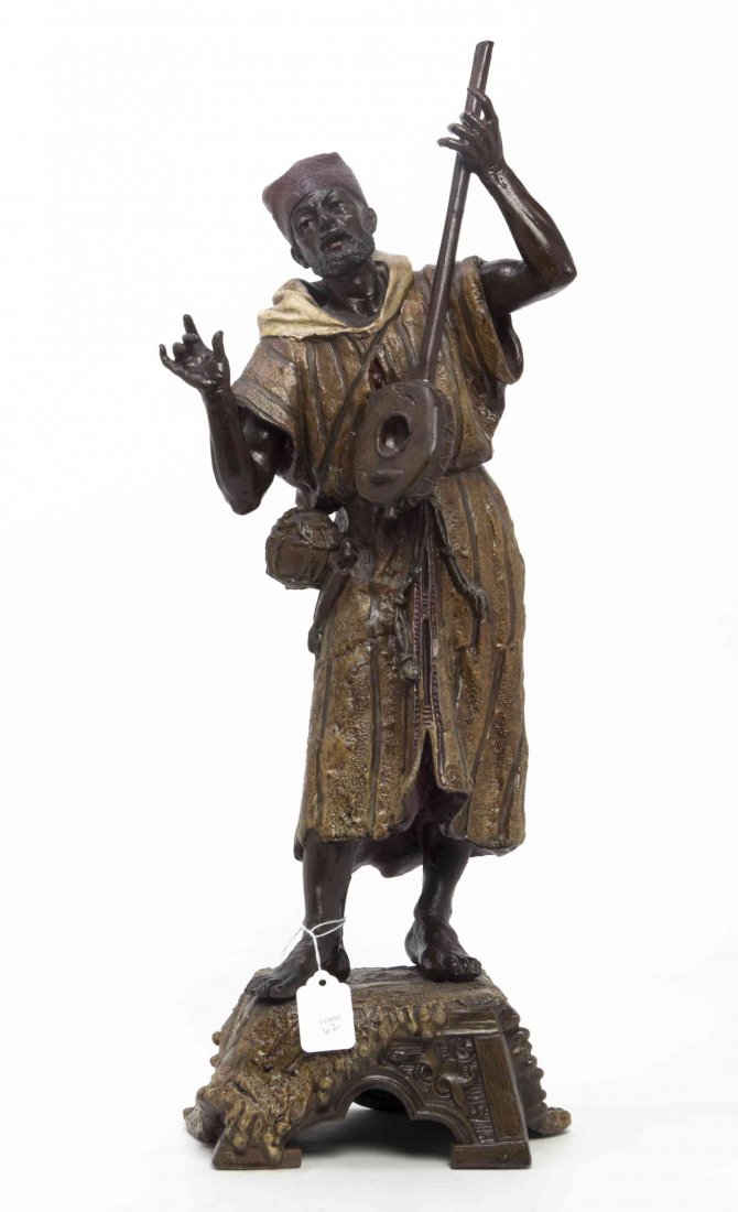An Austrian Style Polychrome Decorated Cast Metal: An Austrian Style Polychrome Decorated Cast Metal Figure, depicting an Middle Eastern musician, standing on a carpet draped pedestal. Height 23 1/4 inches.