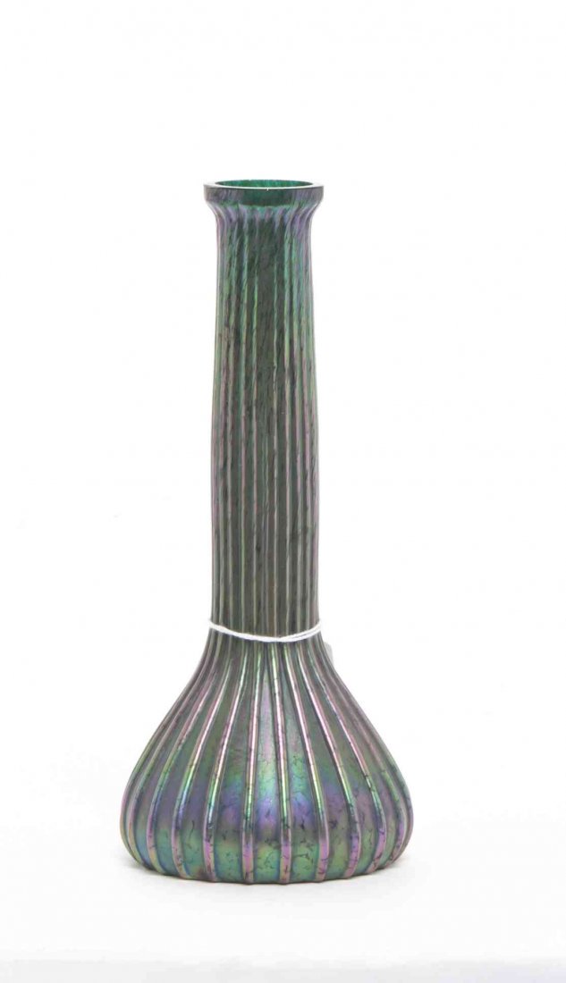 An Austrian Glass Vase, likely Loetz or Kralik, Height: An Austrian Glass Vase, likely Loetz or Kralik, of bottle form with ribbed decoration throughout, having spurious Steuben Aurene mark to base. Height 8 1/4 inches.