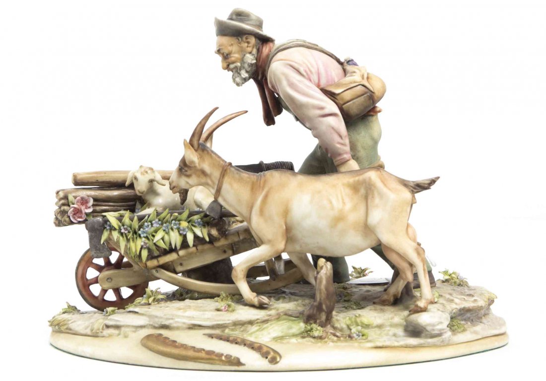 A Borsato Porcelain Figural Group, Width 9 1/2 inches.: A Borsato Porcelain Figural Group, modeled as an old man in a hat pushing a wheelbarrow as a goat walks besides him, set on a naturalistic base. Width 9 1/2 inches.