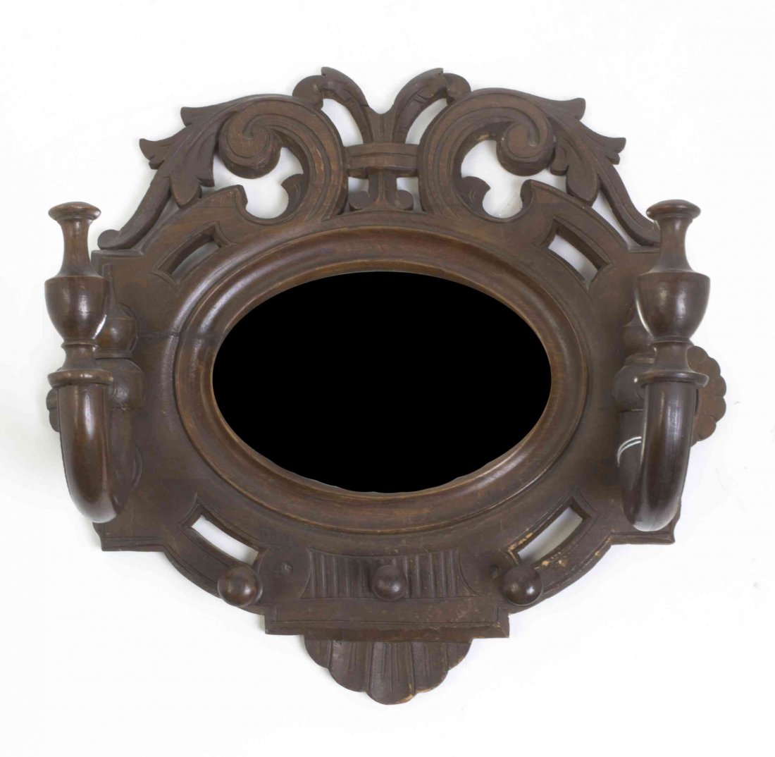 A Victorian Walnut Coat Rack, Width 13 3/4 inches.: A Victorian Walnut Coat Rack, centered with an oval mirror flanked by two hooks, having stylized foliate carving throughout. Width 13 3/4 inches. Property from the Estate of Norman and Dorothy Holmes,