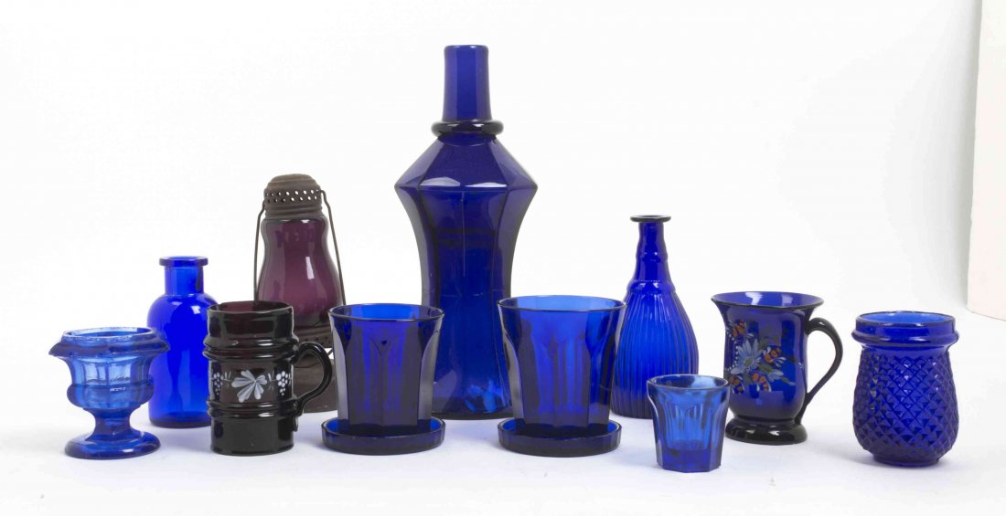 A Collection of Cobalt Glass Articles, Height of first: A Collection of Cobalt Glass Articles, comprising a faceted bottle, three tumblers, two coasters, a bottle, two vases and four others; 13 items total. Height of first 10 5/8 inches. Property from the