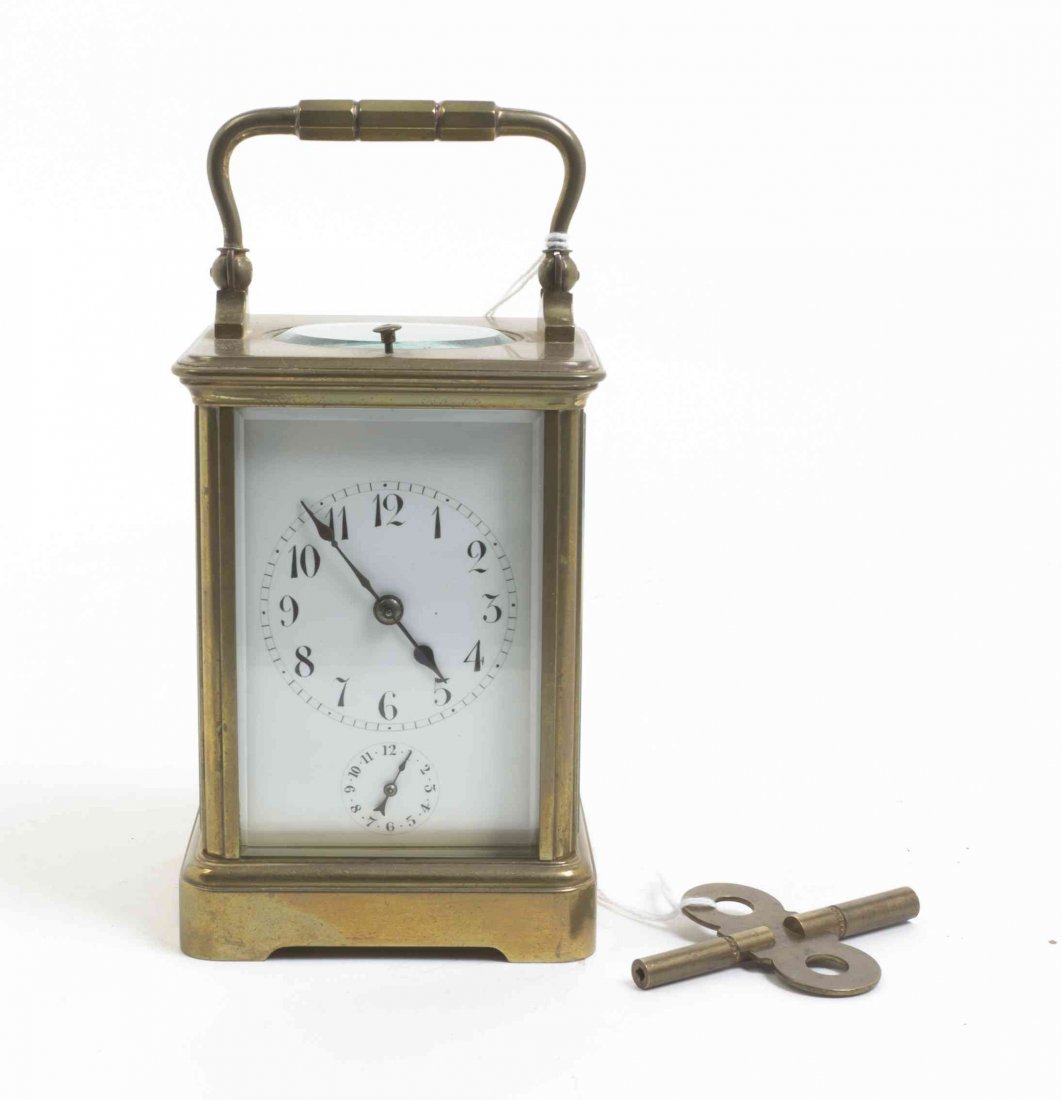 A French Brass Carriage Clock, Height over handle 6: A French Brass Carriage Clock, having time and alarm movement. Height over handle 6 inches. Property from the Estate of Norman and Dorothy Holmes, Wilmette, Illinois