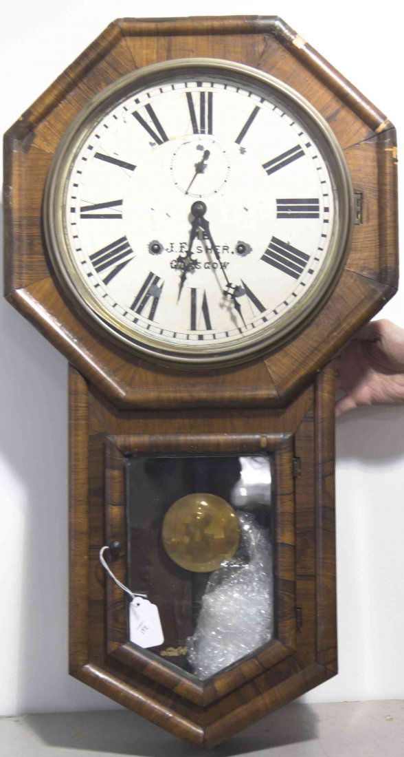 A Mahogany Regulator Clock, M.B.J. Fisher, Height 31: A Mahogany Regulator Clock, M.B.J. Fisher, having an octagonal face and a circular dial with Roman hours, further inset with seconds hand. Height 31 inches. Property from the Estate of Norman and Doro