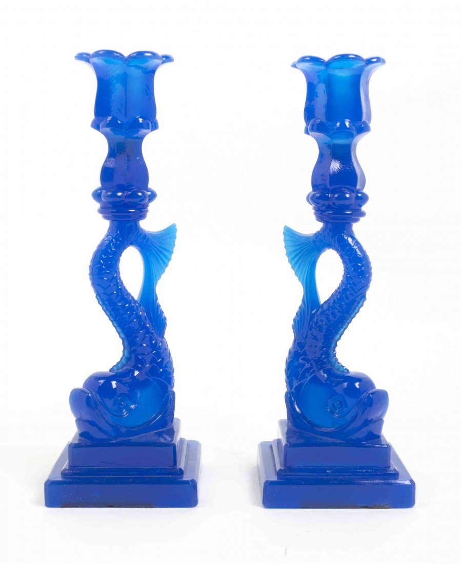 A Pair of American Molded Glass Candlesticks, Height 10: A Pair of American Molded Glass Candlesticks, each of dolphin form, raised on a stepped base. Height 10 3/4 inches. Property from the Estate of Norman and Dorothy Holmes, Wilmette, Illinois