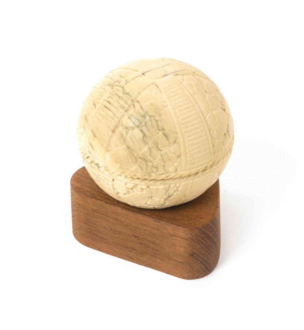 A Continental Carved Ivory Sphere, Diameter 2 1/4: A Continental Carved Ivory Sphere, opening to a relief carved figural scene titled Entrevue de la Reine Elisabeth et de Marie Stuart, raised on a later triangular wood stand. Diameter 2 1/4 inches.