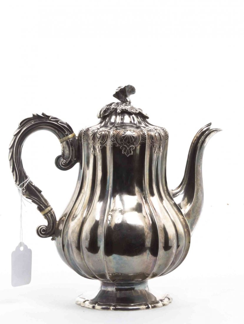 A George IV Silver Teapot, William Eley II, London,: A George IV Silver Teapot, William Eley II, London, 1826, paneled baluster form, raised on shaped circular foot, fully marked on base; 26 ozt 12 dwt. Height 9 1/4 inches. Property from the Estate of D