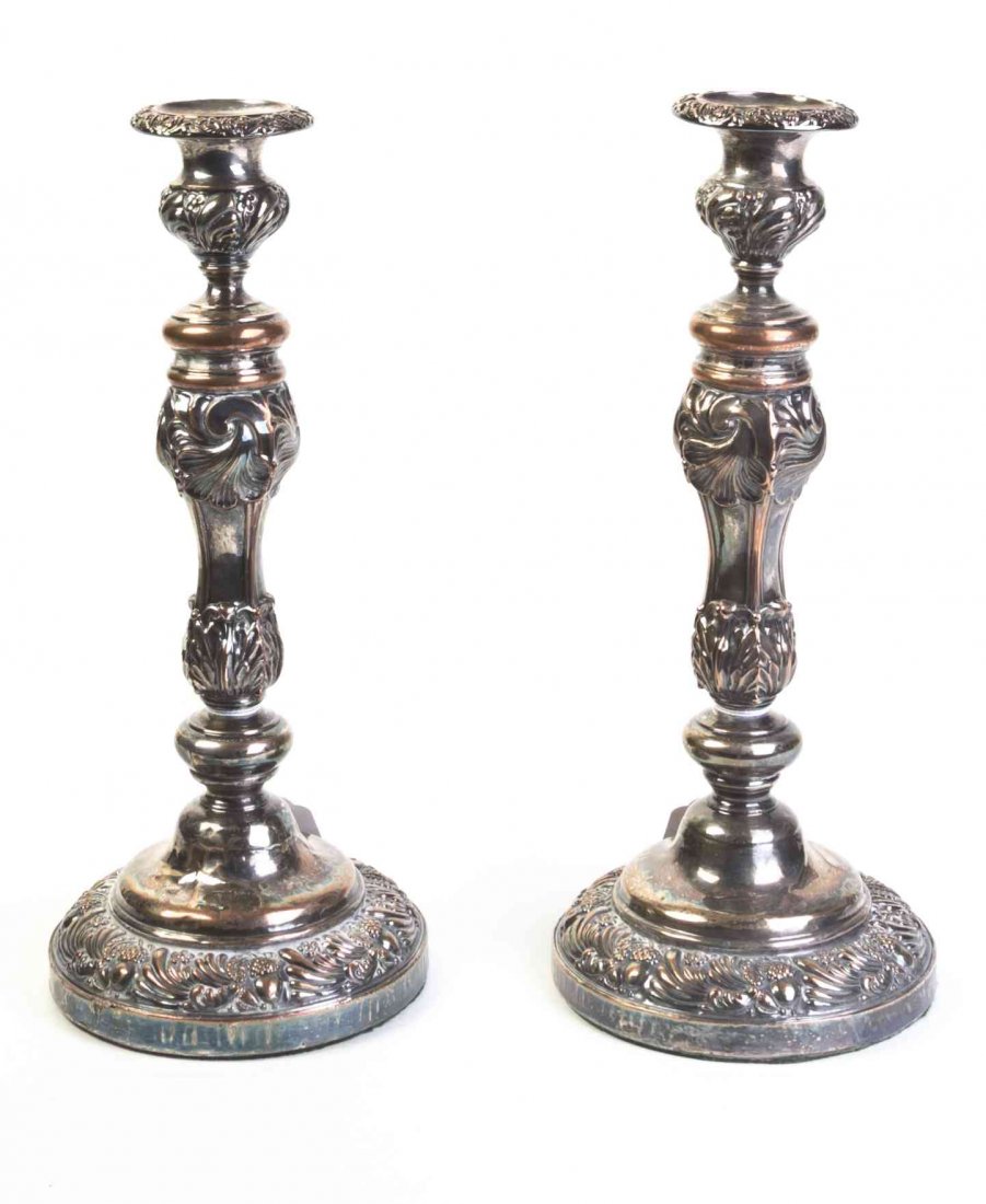 A Pair of English Silver-Plate Candlesticks, Height 12: A Pair of English Silver-Plate Candlesticks, each of baluster form, cast with stylized foliate and shell decoration. Height 12 1/4 inches. Property from the Estate of Norman and Dorothy Holmes, Wilmet