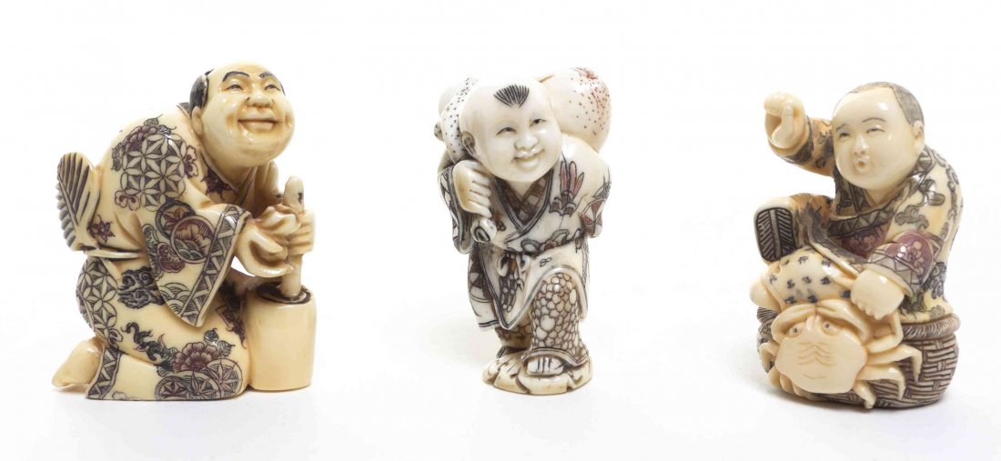 A Group of Three Carved Ivory Netsuke, Height of: A Group of Three Carved Ivory Netsuke, with polychrome decoration, depicting a child with peaches and another a crab. Height of tallest 2 1/4 inches.