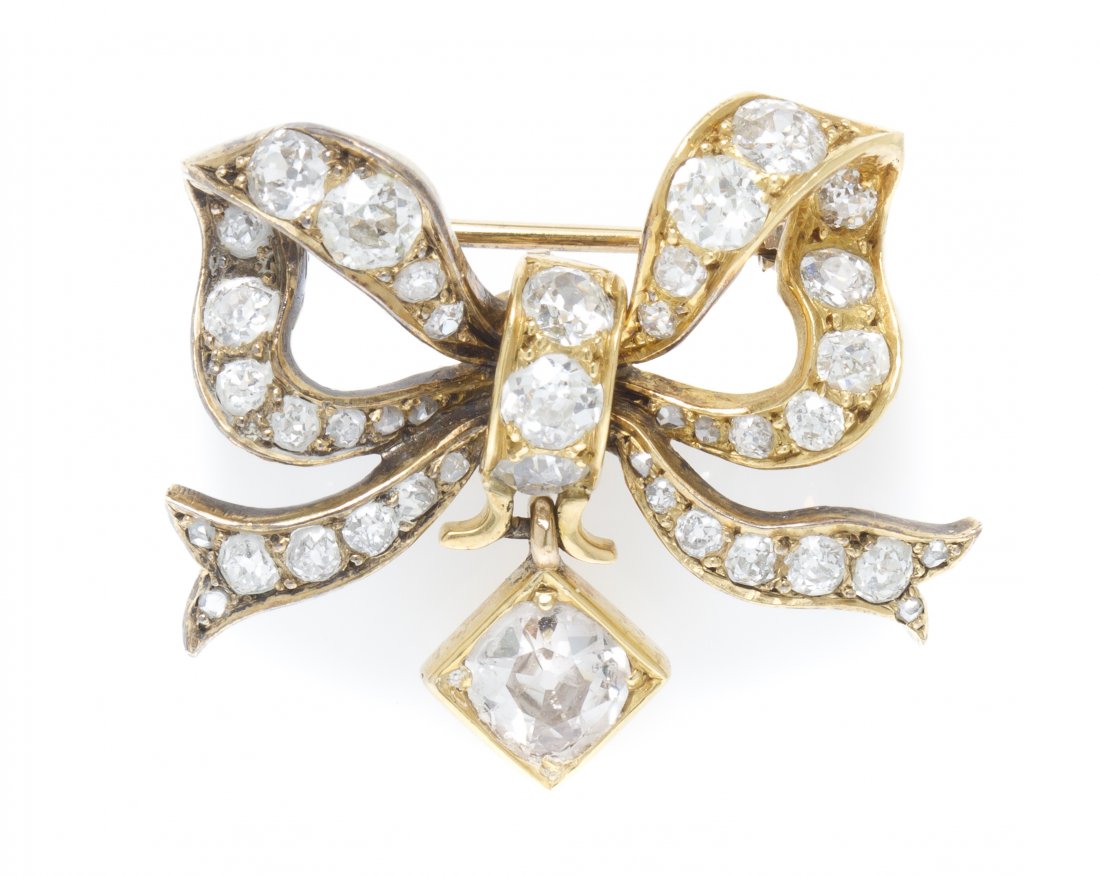 An Antique Yellow Gold and Diamond Bow Brooch, 5.80: An Antique Yellow Gold and Diamond Bow Brooch, containing one old European cut diamond weighing approximately 0.70 carat, together with 46 old European and rose cut diamonds weighing approximately 1.8