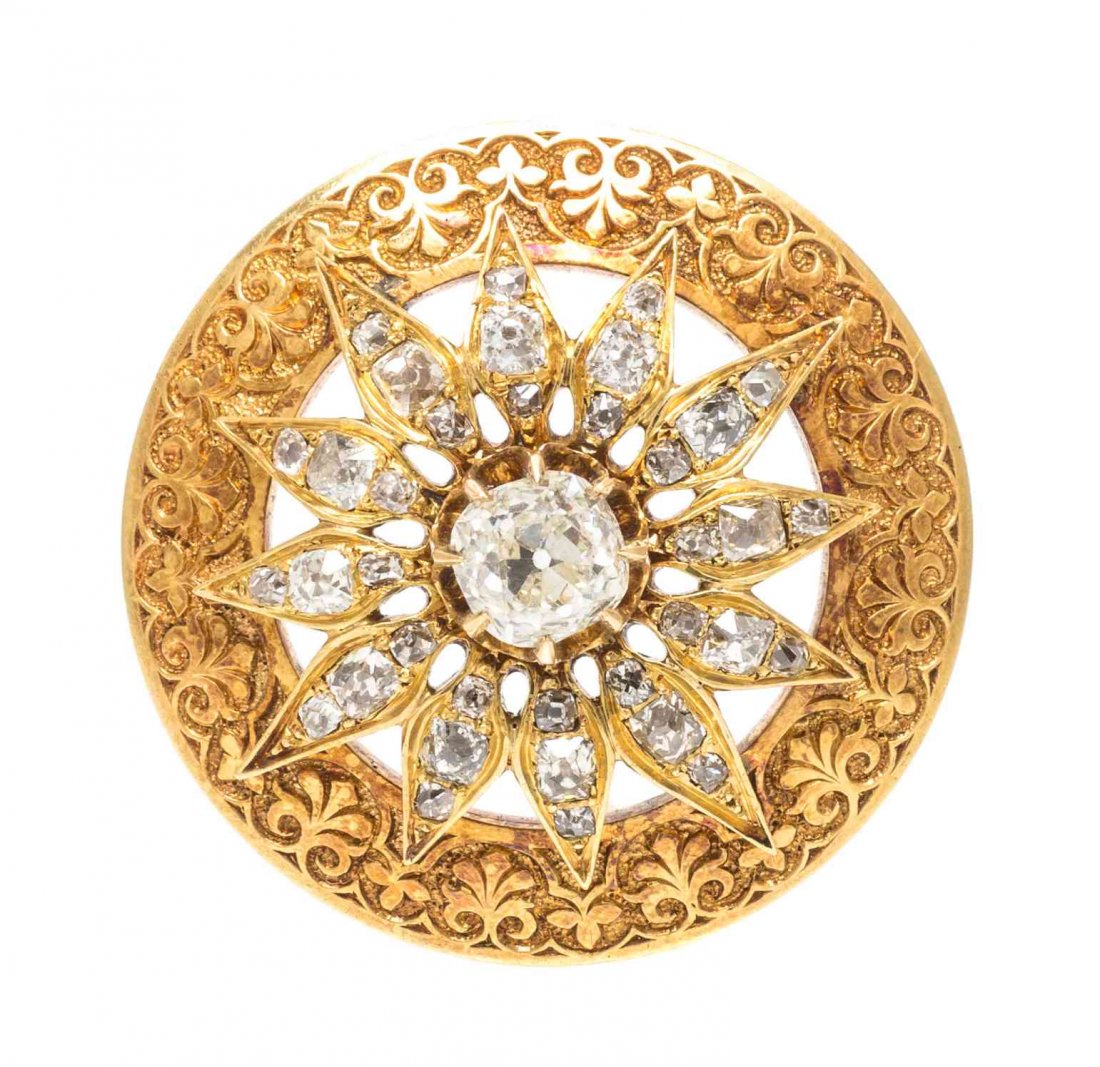 A Victorian 18 Karat Yellow Gold and Diamond Brooch,: A Victorian 18 Karat Yellow Gold and Diamond Brooch, consisting of a central openwork circular burst design containing one old mine cut diamond weighing approximately 1.10 carats and 36 old mine cut d