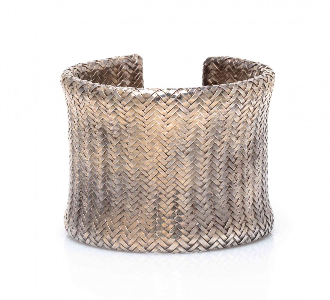 A Sterling Silver Basketweave Cuff Bracelet, Angela: A Sterling Silver Basketweave Cuff Bracelet, Angela Cummings, of concave design, measuring approximately 49.00 mm wide. Stamp: 1984 1985 CUMMINGS STERLING. 45.50 dwts.