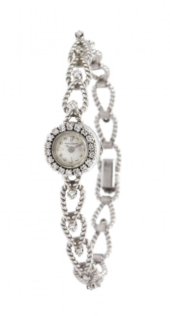 A Vintage 18 Karat White Gold and Diamond Wristwatch,: A Vintage 18 Karat White Gold and Diamond Wristwatch, Jaeger LeCoultre, the bezel and bracelet containing numerous round brilliant cut diamonds weighing approximately 0.60 carat total, 13.20 mm case d