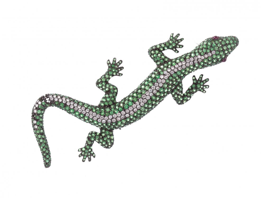 An 18 Karat White Gold, Tsavorite Garnet, Diamond and: An 18 Karat White Gold, Tsavorite Garnet, Diamond and Ruby Lizard Brooch, containing numerous pave set round brilliant cut diamonds weighing approximately 0.95 carat total, numerous pave tsavorite gar