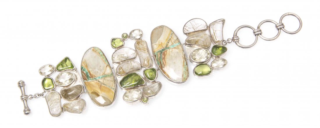 A Sterling Silver, Variscite, Peridot, Golden: A Sterling Silver, Variscite, Peridot, Golden Labradorite and Rutilated Quartz Bracelet, Starborn, consisting of a toggle bracelet containing cabochon cut of variscite, peridot, rutilated quartz and o