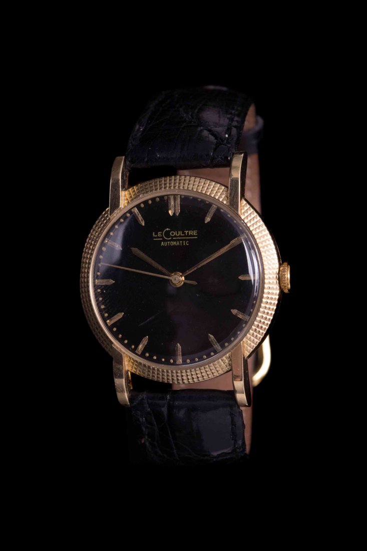 An 18 Karat Yellow Gold Wristwatch, LeCoultre, Circa: An 18 Karat Yellow Gold Wristwatch, LeCoultre, Circa 1950, 33.00 mm case diameter, black dial signed LeCoultre, applied gold faceted index numerals, gilt sword hands with center sweep seconds hand, cl