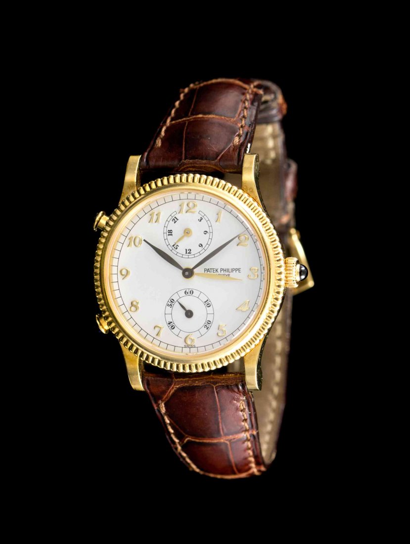 An 18 Karat Yellow Gold Ref. 4864J Travel Time: An 18 Karat Yellow Gold Ref. 4864J Travel Time Wristwatch, Patek Philippe, 29.00 mm case diameter, white dial signed PATEK PHILIPPE, applied gold Breguet numerals, oxidized black feuille hands with po