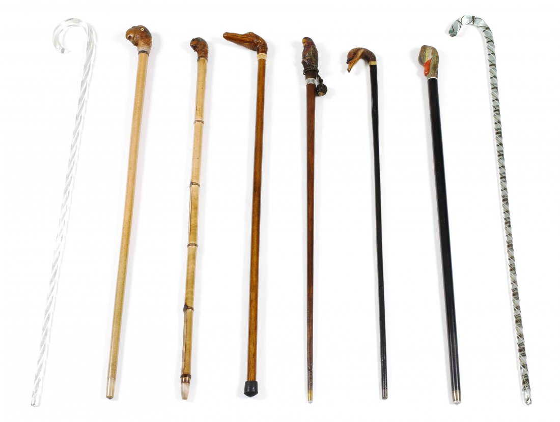 A Collection of Eight Canes and Walking Sticks, Height: A Collection of Eight Canes and Walking Sticks, comprising a malacca with composition alligator head handle; a carved wood duck handle with gold-filled collar engraved with an earl's coronet; a malacc