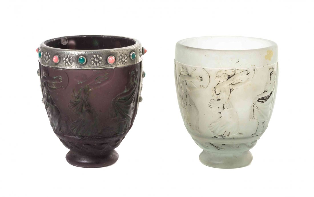 Two George de Feure Molded Glass Vases, French: Two George de Feure Molded Glass Vases, French (1868-1943), each of tapering from with a continuous scene of classical figures, one with an amethyst ground with silvered stone inset mounts, each with
