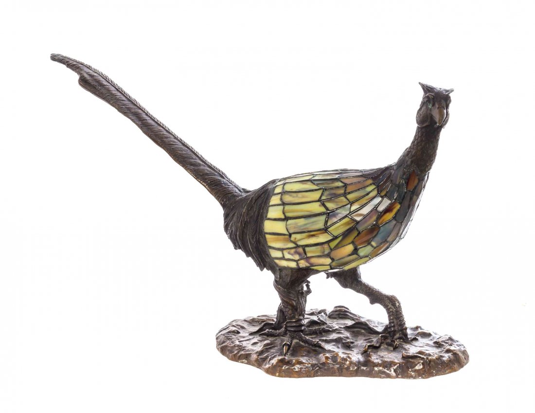 A Charles Schneider Leaded Glass and Bronze Figural: A Charles Schneider Leaded Glass and Bronze Figural Lamp, depicting a striding pheasant on a naturalistic base, signed Charles Schneider. Length overall 24 x height 15 1/2 inches.