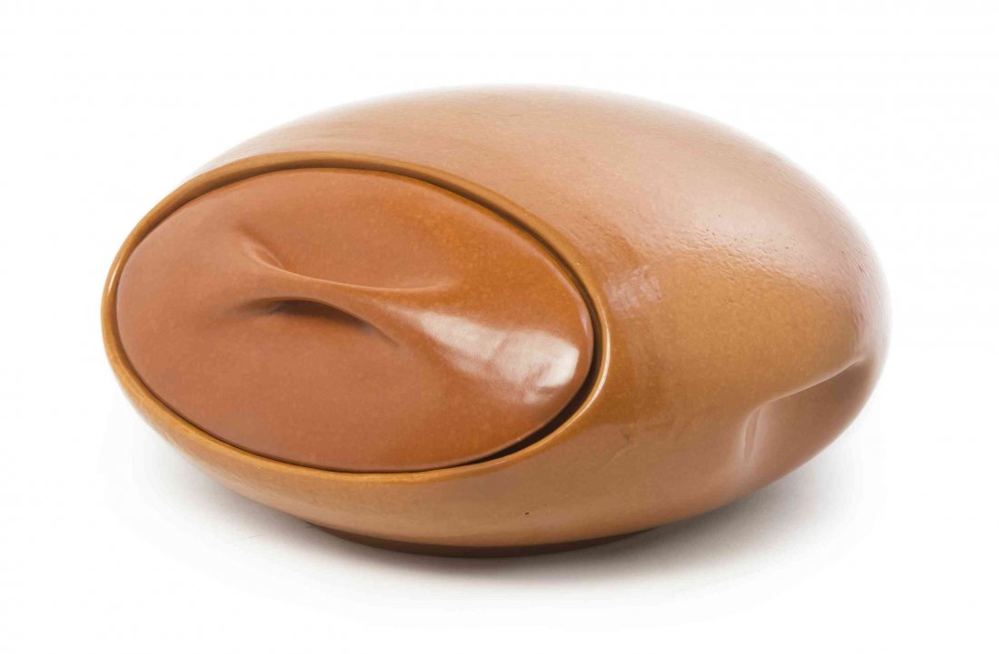 A Roseville Pottery Bun Warmer, Width 11 1/2 inches.: A Roseville Pottery Bun Warmer, Raymor, designed by Ben Siebel, of flattened spherical form with dimpled handles and a sienna ground, signed Raymor Roseville USA, further marked ovenproof. Width 11 1/