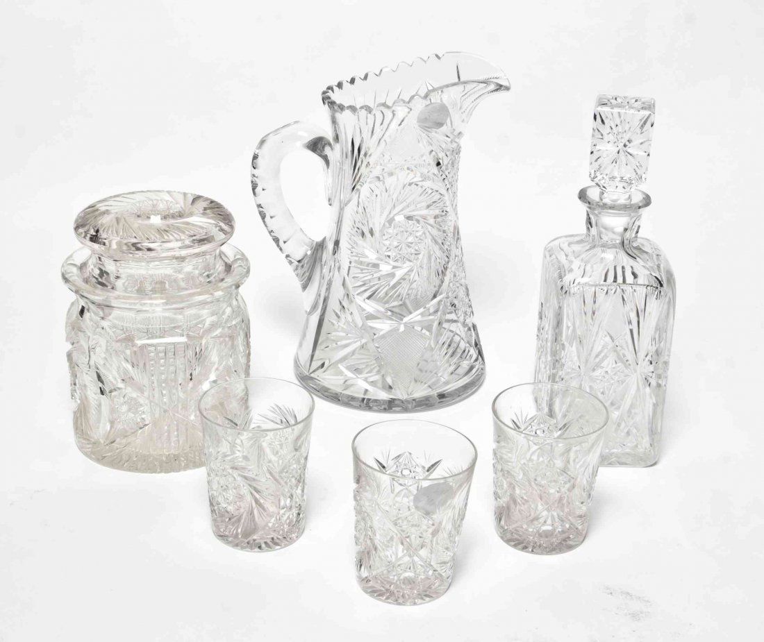 A Collection of Cut Glass Articles, Height of first 10: A Collection of Cut Glass Articles, 20TH CENTURY, comprising a pitcher, a bottle with stopper, a covered cookie jar and nine water glasses. Height of first 10 3/8 inches. Property from the Estate of R