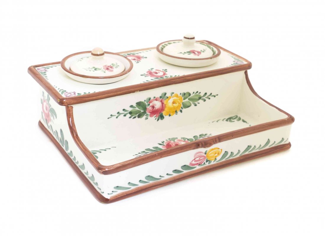 A Continental Faience Inkstand, Width 9 1/2 inches.: A Continental Faience Inkstand, the rectangular tray fitted with two cylindrical inkwells with covers, decorated throughout to show floral sprays. Width 9 1/2 inches.