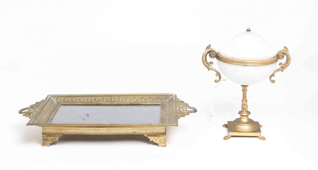 A French Empire Style Gilt Metal Vanity Tray, Width of: A French Empire Style Gilt Metal Vanity Tray, early 20th century, together with a gilt bronze mounted opalescent covered compote. Width of first over handles 15 1/2 inches. Property from the Estate an