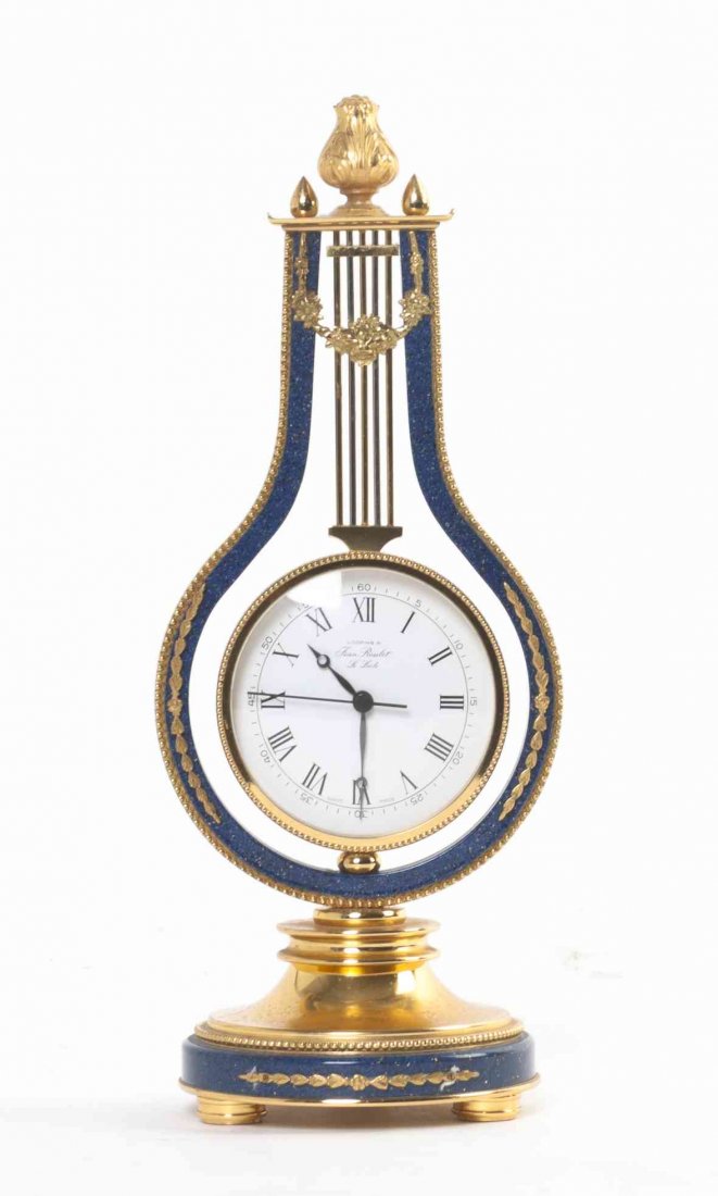 A Gilt Metal and Faux Lapis Desk Clock, Height 9 3/4: A Gilt Metal and Faux Lapis Desk Clock, of lyre form, with looping by Jean Roulet Le Locle. Height 9 3/4 inches. Property from the Estate and Trust of Elise Reeder Olton, Boca Raton, Florida