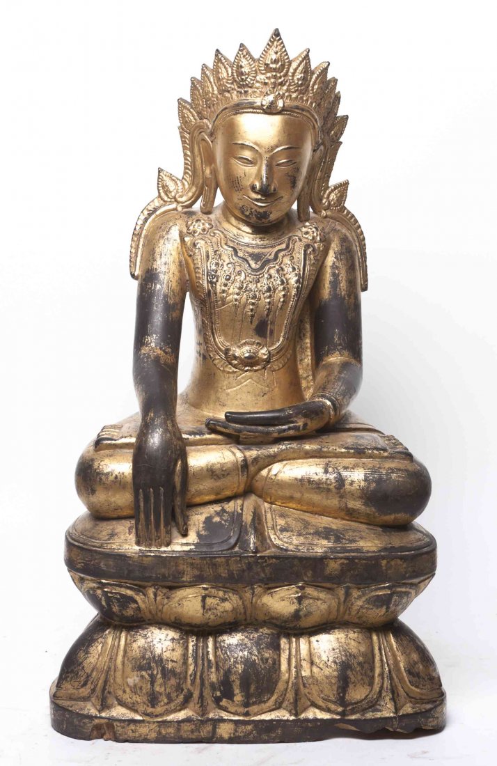 A Southeast Asian Carved Wood Buddhist Figure, Height: A Southeast Asian Carved Wood Buddhist Figure, the deity depicted with tiered crown and necklace, with allover gilt decoration, raised on a lotus seat, faux-aged. Height 26 3/4 inches. Property from t