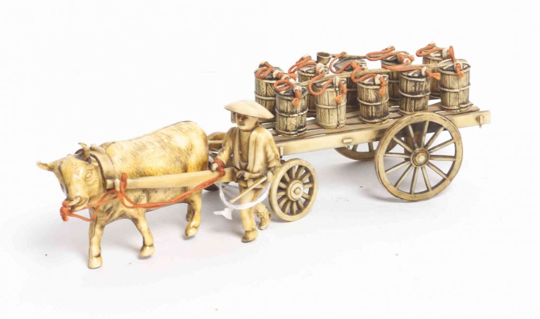 A Japanese Faux Ivory Figural Group, Length of model 9: A Japanese Faux Ivory Figural Group, depicting a farmer with ox and cart. Length of model 9 inches. Property from the Estate and Trust of Elise Reeder Olton, Boca Raton, Florida