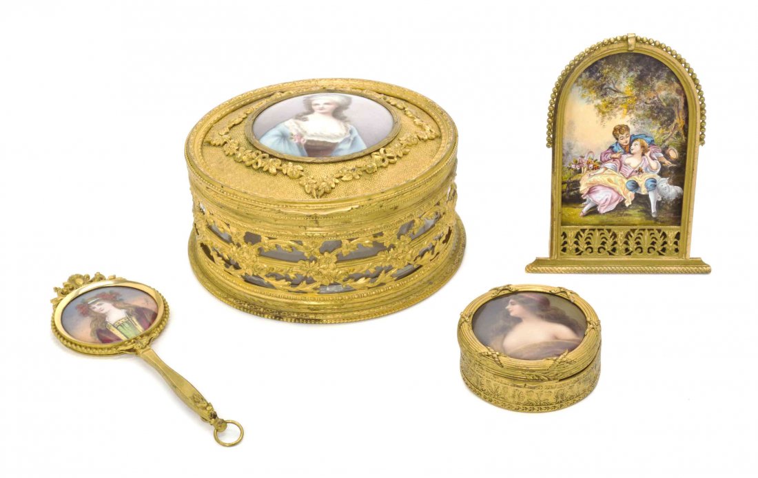 Four Enameled or Porcelain Inset Gilt Metal Table: Four Enameled or Porcelain Inset Gilt Metal Table Articles, comprising two circular boxes, a hand mirror and a plaque, the first three decorated with a portrait, the third a figural scene. Diameter of
