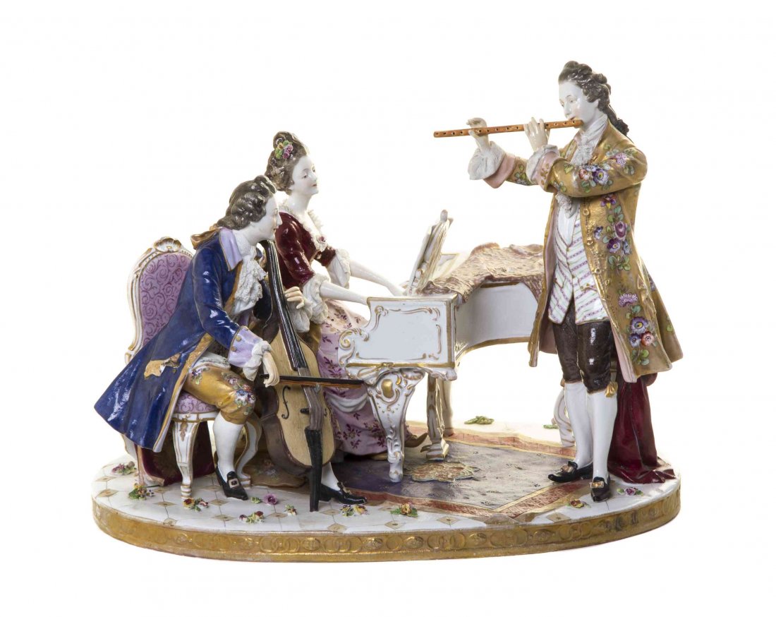 A Continental Porcelain Figural Group, Width 17 inches.: A Continental Porcelain Figural Group, depicting a trio of musicians in 18th century attire, a lady playing the piano, a man playing the cello and a man playing the flute. Width 17 inches. Property fr