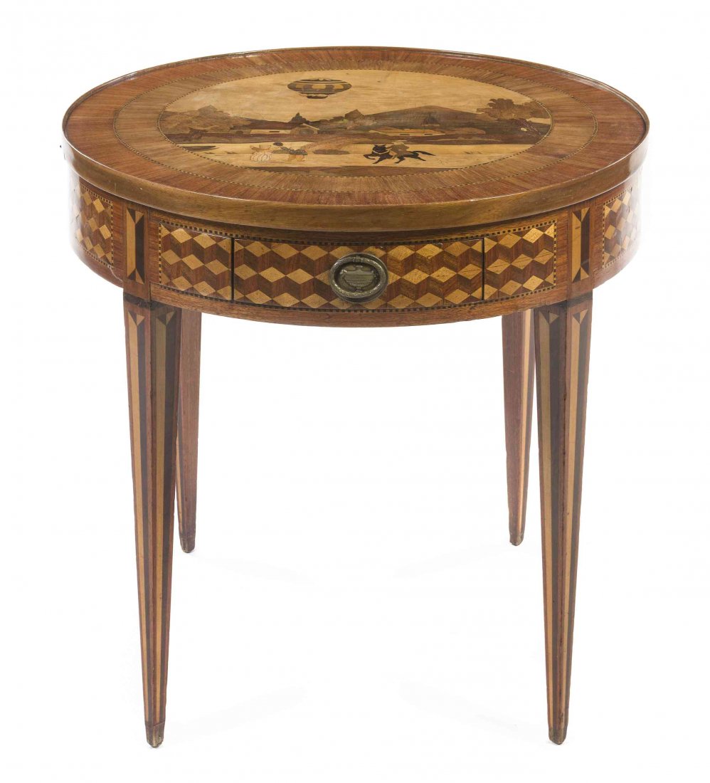 A Louis XVI Style Marquetry and Parquetry Inlaid Games: A Louis XVI Style Marquetry and Parquetry Inlaid Games Table, having a circular top inlaid to show figures and a hot air balloon in an architectural landscape, above a parquetry inlaid frieze with two
