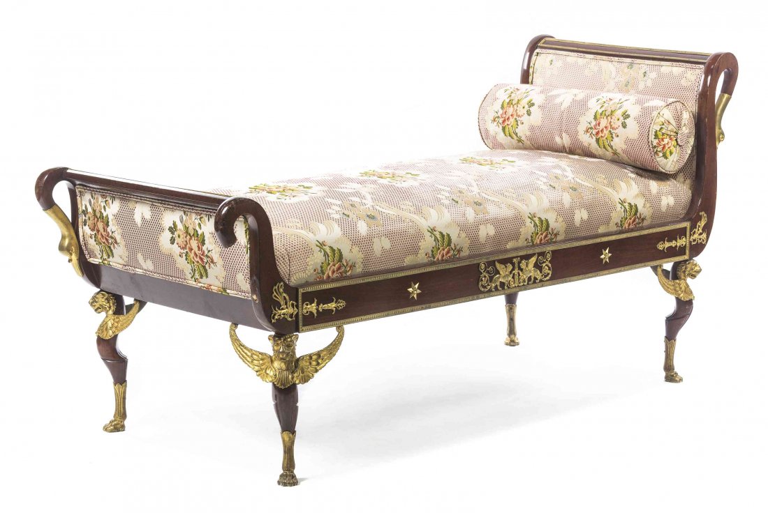 A French Empire Style Gilt Bronze Mounted Mahogany: A French Empire Style Gilt Bronze Mounted Mahogany Daybed, having an everted back with swan form terminals, raised on short cabriole legs headed by winged lions and ending in paw feet. Height 36 x wid