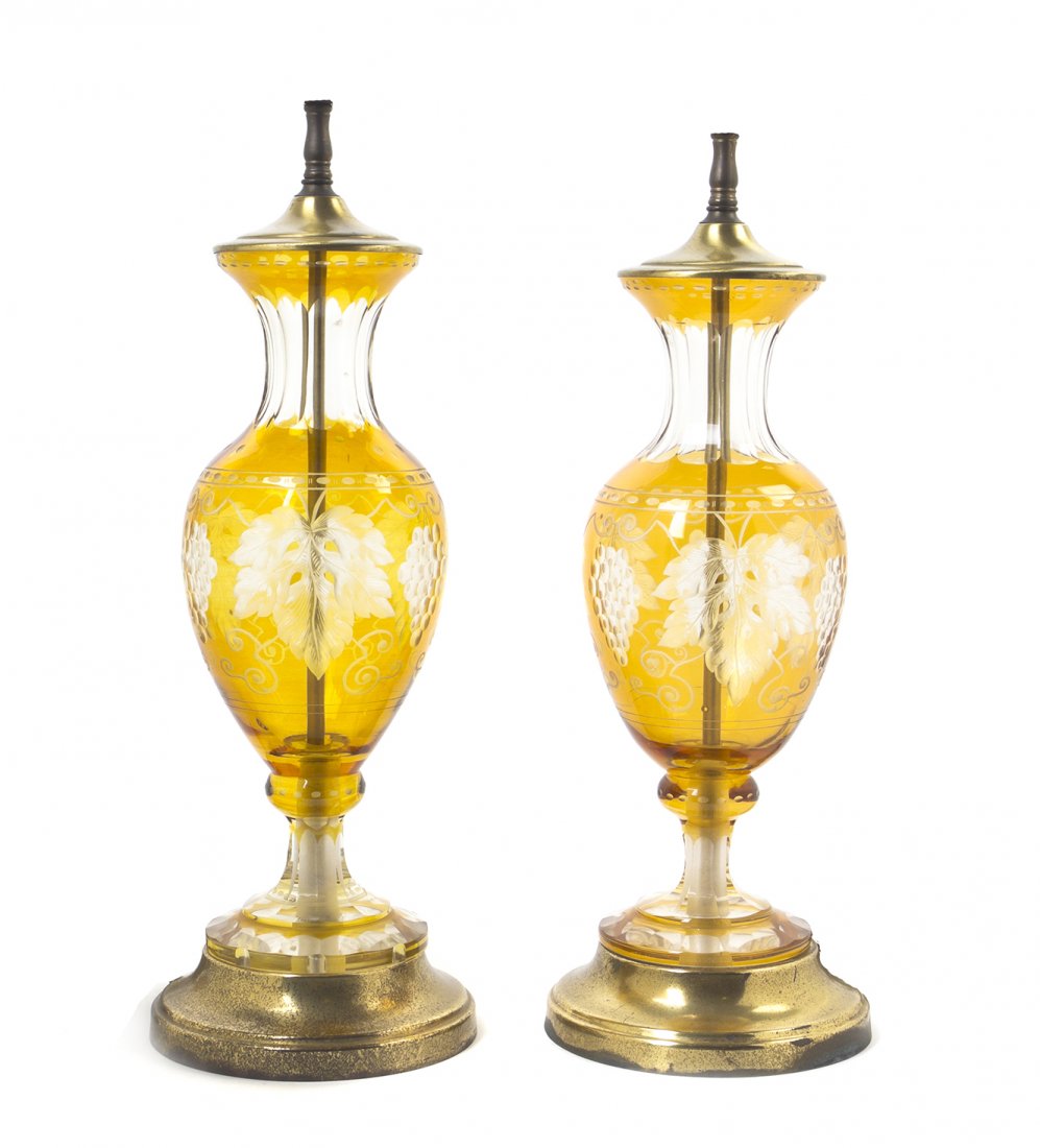 A Pair of Bohemian Yellow Cut to Clear Glass Urns,: A Pair of Bohemian Yellow Cut to Clear Glass Urns, each of baluster form, decorated with grape clusters and leaves, mounted as lamps. Height 13 3/4 inches. Property from the Estate of Norman and Dorot