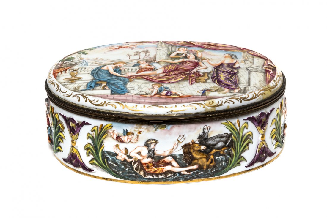 A Capodimonte Porcelain Table Casket, Width 13 inches.: A Capodimonte Porcelain Table Casket, of oval form with a hinged lid and figural decoration in relief. Width 13 inches. Property from the Estate of a Prominent Midwest Collector