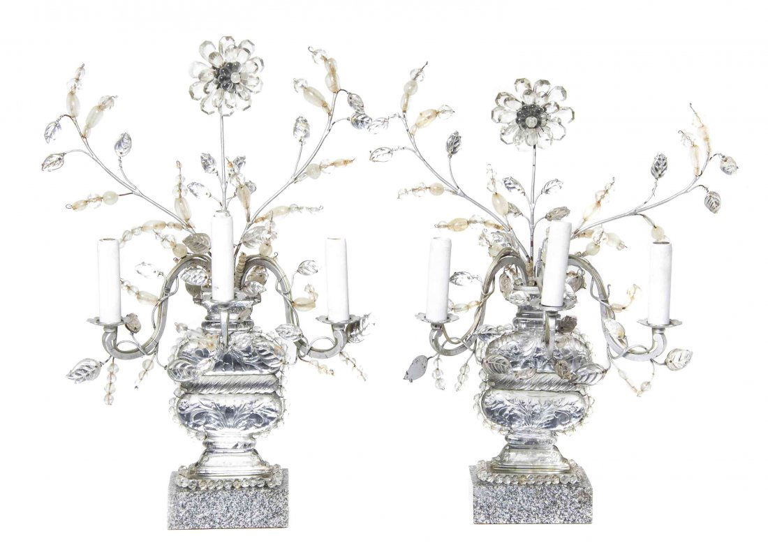 A Pair of Silvered Metal and Glass Three-Light: A Pair of Silvered Metal and Glass Three-Light Candelabra, IN THE MANNER OF MAISON BAGUES, each in the form of an urn issuing flowers and leafy candle arms. Height 23 inches.
