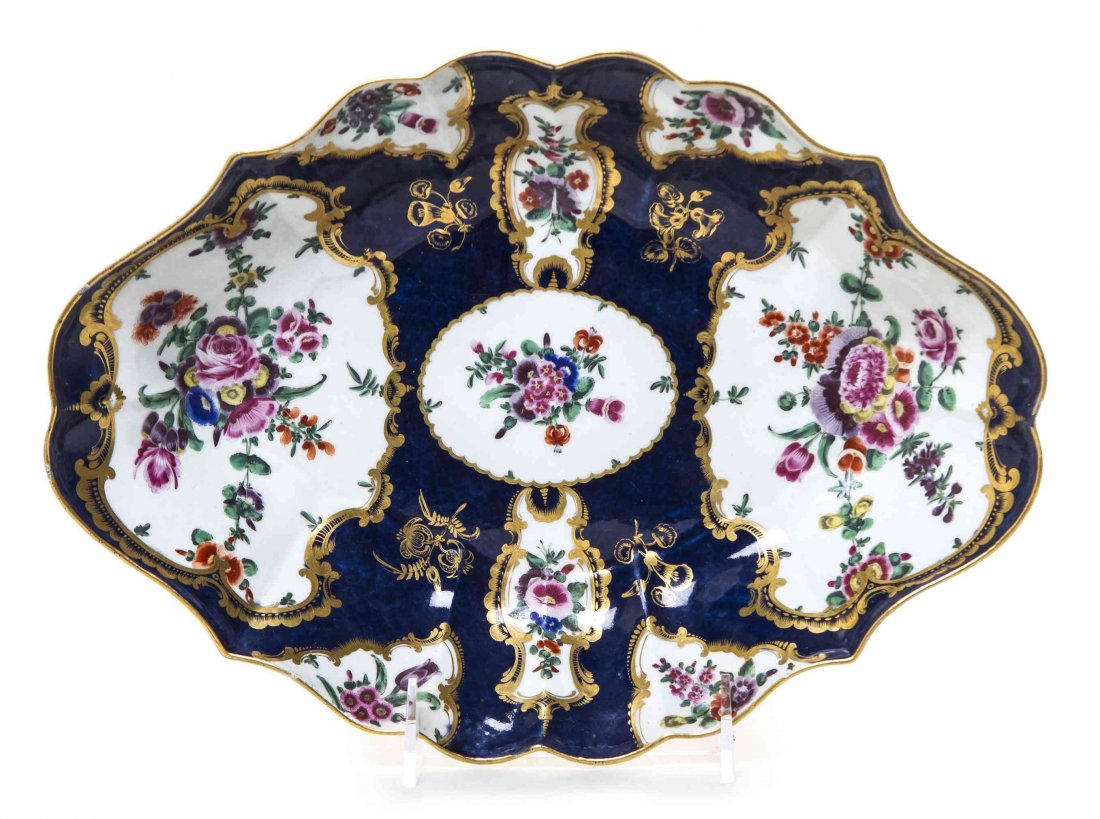 A Worcester Blue Scale Porcelain Dessert Dish, Width 11: A Worcester Blue Scale Porcelain Dessert Dish, CIRCA 1770, of lozenge form, painted to show floral sprays within gilt cartouches, bearing a blue square seal mark to the underside. Width 11 3/4 inches.