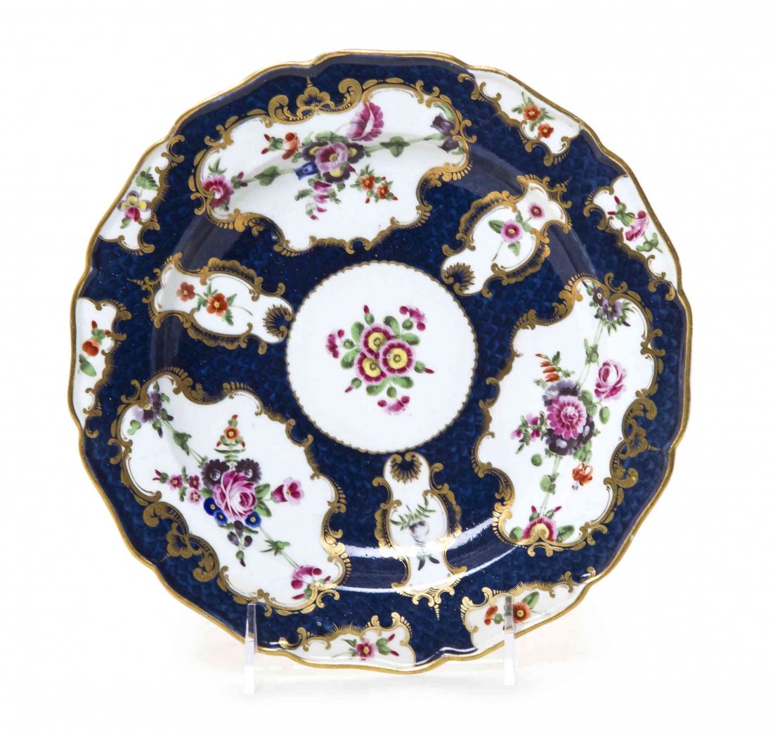 A Worcester Blue Scale Porcelain Plate, Diameter 8 7/8: A Worcester Blue Scale Porcelain Plate, CIRCA 1770, painted to show floral sprays within vacant reserves, and bearing a blue square seal mark to the underside. Diameter 8 7/8 inches. Property from the