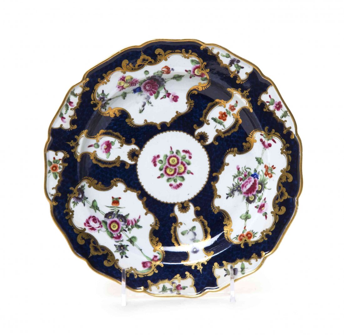 A Worcester Blue Scale Porcelain Plate, Diameter 8 7/8: A Worcester Blue Scale Porcelain Plate, CIRCA 1770, painted to show floral sprays within vacant reserves, and bearing a blue square seal mark to the underside. Diameter 8 7/8 inches. Property from the