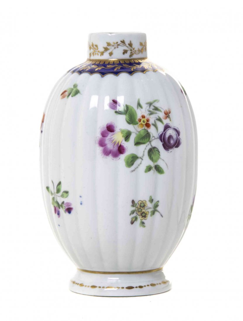 A Worcester Polychrome Porcelain Tea Caddy, Height 5: A Worcester Polychrome Porcelain Tea Caddy, CIRCA 1775, of lobed ovoid form, painted to show floral sprays, bearing a blue open crescent mark to the underside. Height 5 1/2 inches. Property from the C
