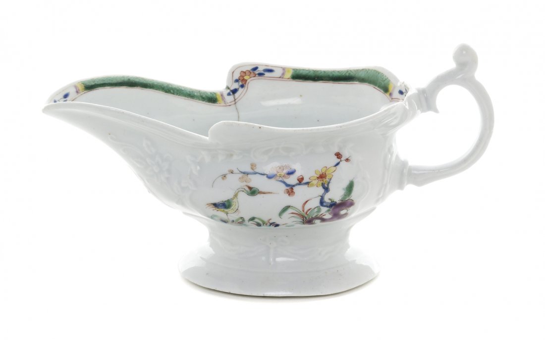A Worcester Polychrome Porcelain Sauce Boat, Length 6: A Worcester Polychrome Porcelain Sauce Boat, CIRCA 1755, of elongated form, painted to show floral sprays and birds, unmarked. Length 6 1/2 inches. Property from the Collection of Norman Lippitt, Calg