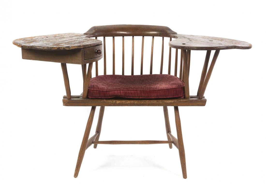 An American Oak Windsor Double Arm Writing Chair,: An American Oak Windsor Double Arm Writing Chair, having a U-shaped spindle back with two shaped writing surfaces, one enclosing a single drawer, above a shaped seat and raised on turned legs joined b