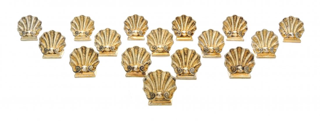 A Set of Sixteen French Gilt Silver-Plate Place Card Ho: A Set of Sixteen French Gilt Silver-Plate Place Card Holders, Christofle, Paris, Late 20th Century, each in the form of a shell, marked on bases. Height 1 1/8 inches. Condition: good condition through