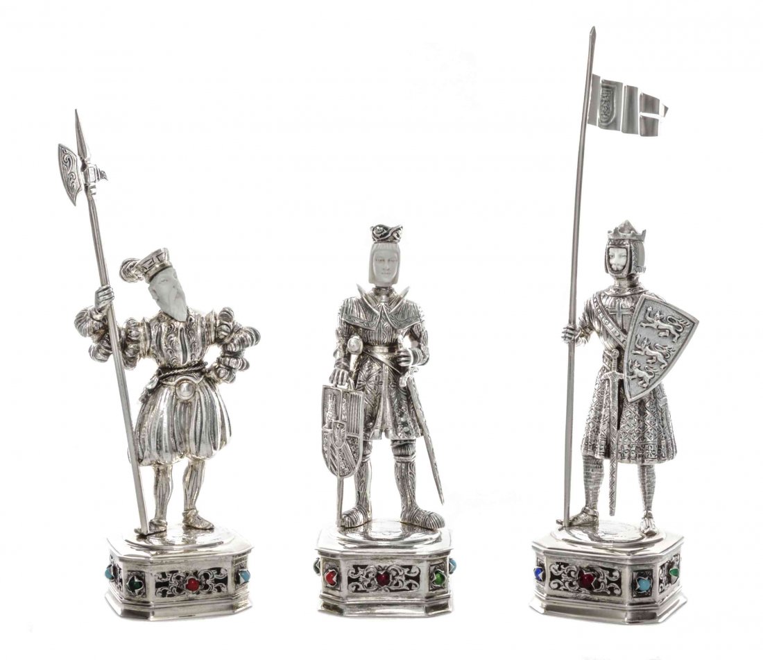 A Set of Three German Silver-Gilt Figures of Knights,: A Set of Three German Silver-Gilt Figures of Knights, Circa 1900, all on square bases with canted corners, the sides pierced and engraved with foliage and mounted with "gems", each supporting a figure