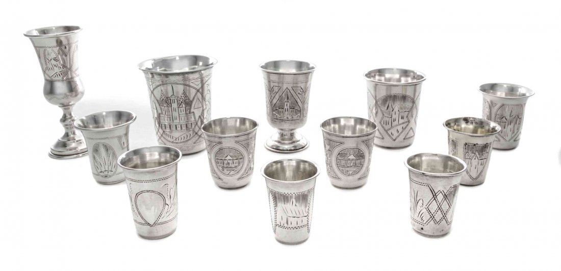 A Group of Twelve Russian Silver Beakers, Height of: A Group of Twelve Russian Silver Beakers, Late 19th Century, in sizes, comprising eight beakers and one cordial engraved with panels enclosing architectural scenes alternating with foliage, and three 