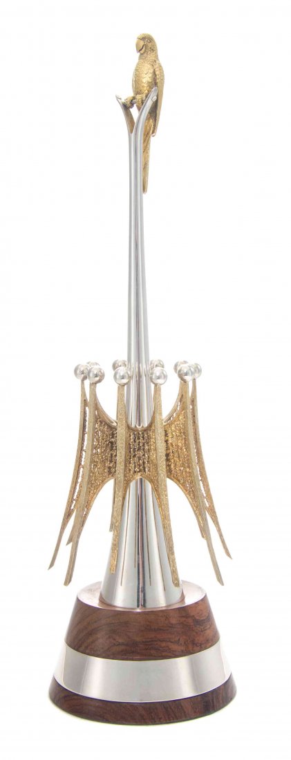 An English Parcel-Gilt Silver Centerpiece, Height: An English Parcel-Gilt Silver Centerpiece, Stuart Devlin, London, 1979, formed as a gilt parrot perched on an elongated conical stem, the lower stem surrounded by stylized gilt buttresses topped by si