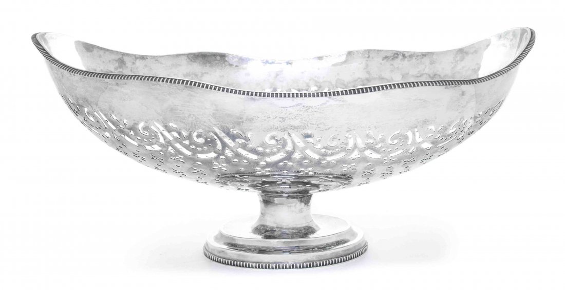 A Silver Large Centerpiece Bowl, Length 17 7/8 inches.: A Silver Large Centerpiece Bowl, oval with undulating rim and gadrooned borders, pierced with flowers and scrolls, underside with transposed marks for Francis Butty & Nicholas Dumee, London, 1770; 45 